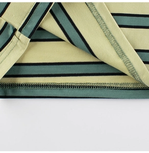 Detailed close-up of the hem stitching on a striped cotton t-shirt for boys