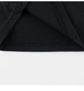 Close-up of fine double-needle stitching on the hem of a black cotton kids T-shirt