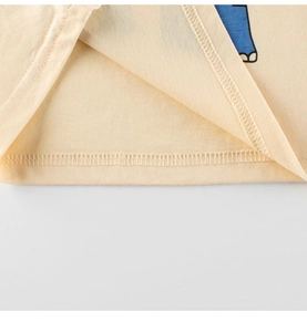 Detail of double-needle stitching on beige cotton kids T-shirt with blue elephant print