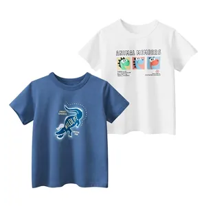 Flat lay of two kids' cotton t-shirts featuring cartoon dinosaur and crocodile prints