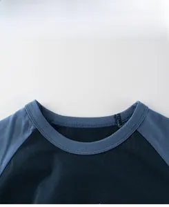 Detail of blue raglan sleeve cotton t-shirt with ribbed neckline and white printed text