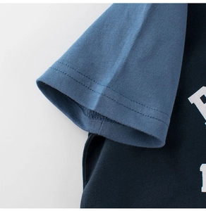 Detail of contrast raglan sleeve and double-needle stitching on cotton kids T-shirt