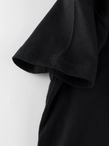 Kids black cotton short sleeve t-shirt showing double needle stitching on sleeve cuff