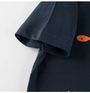 Detailed view of sleeve stitching and cotton fabric on dark blue toddler t-shirt