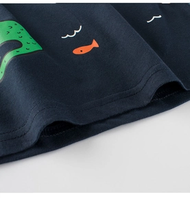 Detail of navy blue kids' cotton shirt with sea creature print and double-needle hem