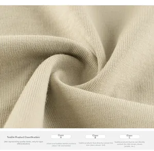 Detail of beige ribbed knit fabric showing soft texture and textile safety standards