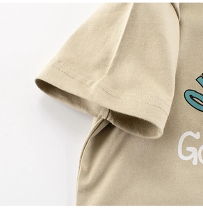 Detail of boys' khaki cotton t-shirt with blue letter print and reinforced stitching