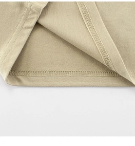Detail view of double-needle stitching on beige cotton knit t-shirt for boys