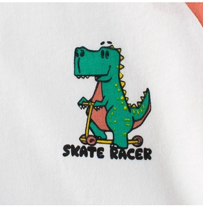 Macro view of dinosaur skate racer print on white cotton t-shirt with orange sleeve