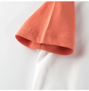 Detail of raglan sleeve stitching and premium cotton fabric on kid's dinosaur t-shirt
