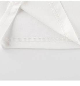 Detail of double-needle stitching and cotton hem on a white children's dinosaur t-shirt
