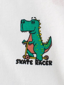 Kids white cotton T-shirt featuring a green cartoon dinosaur on a scooter skate racer print