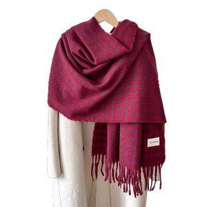 Red and purple plaid cashmere-feel scarf with tassels on white wool coat