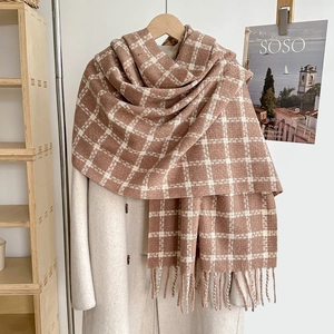 Close-up of thick camel plaid tassel scarf showing soft cashmere-like texture and weave