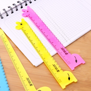 Colorful 15cm giraffe-shaped plastic rulers on a grid notebook for student stationery
