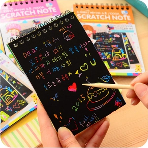 Creative DIY scratch art notebook with wooden stylus and colorful rainbow layers