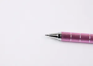 Close-up of pink 0.5mm mechanical pencil showing the silver grid grip and metal tip