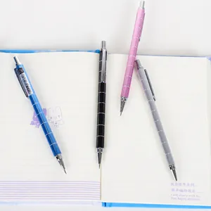 0.5mm metal mechanical pencil set in four colors on a notebook with textured grip