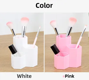 Three-slot hexagonal makeup brush holder in white and pink for desk organization