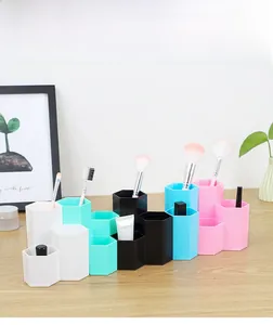 Macro detail of hexagonal multi-slot makeup brush holder in various pastel colors