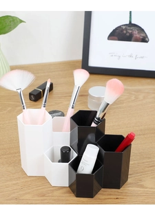 Close-up of hexagonal makeup brush holder and desk organizer on a wooden table