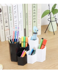 Close-up of hexagonal desk organizer with multi-level compartments for makeup and stationery