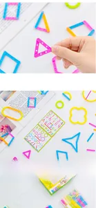 Macro shot of colorful geometric building sticks, educational cards and storage box