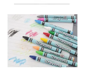 Detail shot of multi-colored crayons with blue paper wraps on a white doodle paper