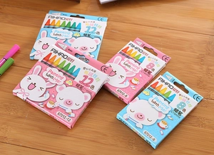 Close-up of 8 and 12 color children crayons sets with cartoon packaging on wood surface