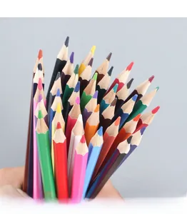 Close-up of a hand holding a bundle of colorful wooden pencils for drawing and sketching
