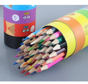 Detail view of multicolored colored pencils scattered from a cylindrical paper tube box
