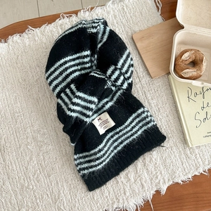 Close-up of black and mint green striped knit scarf with soft mohair texture