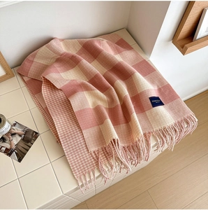 Detailed view of pink and beige checkered scarf with soft fringe and logo label