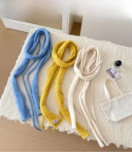 Macro detail of three-color knitted wool scarves in blue, yellow and beige textures