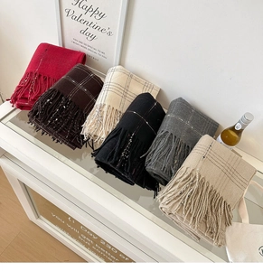 Detail view of multi-color plaid cashmere-like scarves with tassel fringe in six colors