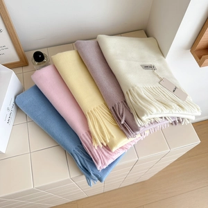 Soft wool scarf with fringe available in blue, pink, and beige for winter warmth