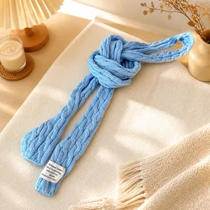 Light blue cable knit skinny scarf for women with minimalist brand woven label tag
