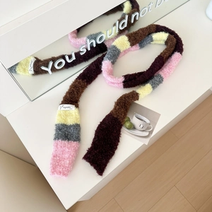 Rainbow striped knitted scarf in pink, yellow and grey on white surface with reflection