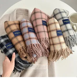 Detail shot of multi-color plaid scarves with soft fringe and elegant brand label