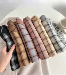 Detail of colorful plaid cashmere-feel scarves with tassels in multiple classic colors