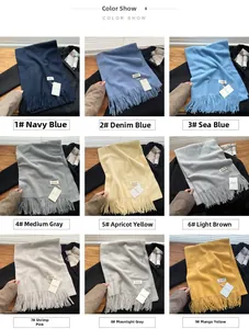 Detailed color show of soft tassel scarves in nine shades including navy and mango