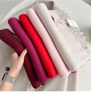 Detailed close-up of soft tassel scarves in multiple colors for autumn and winter