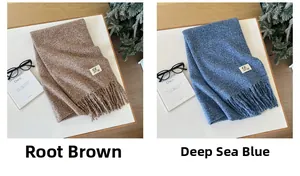 Detail of solid color knitted scarves with fringe in brown and blue marl finishes
