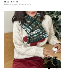 Close-up of Fair Isle wool scarf with vintage jacquard patterns in green and brown colors