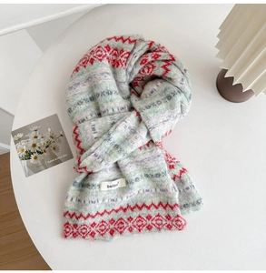 Detailed knit texture of Fair Isle wool blend scarf with geometric patterns and soft fringe