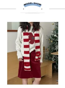 Detail of red and white striped knit scarf with practical pockets on a model