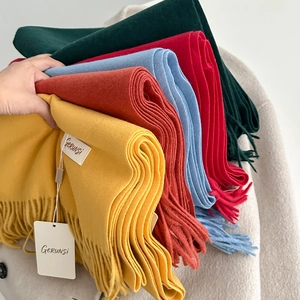 Colorful soft cashmere-feel scarves with tassels in bright yellow, red and blue hues