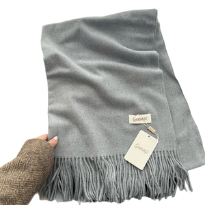 Solid gray winter cashmere-feel scarf with tassels and minimalist brand label