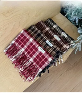 Close-up of checkered cashmere-feel scarves with fringe details and woven brand labels
