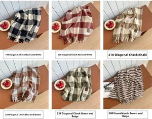 Detail showcasing variety of plaid and houndstooth tassel scarves in multiple colors